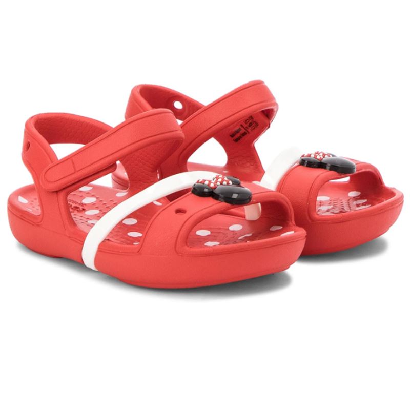 Crocs Lina Minnie Sandal Kids 204999 otroški sandali z Minnie Mouse motivom, nastavljivimi paščki in Croslite™ podplatom za udobje, stabilnost in brezskrbno poletno igro.