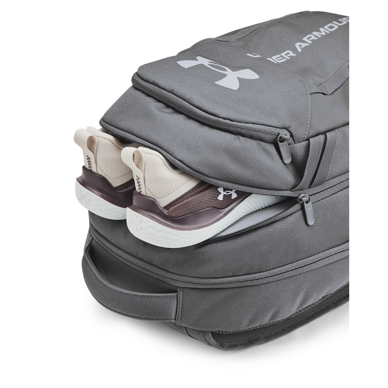 Discover the Under Armour Hustle 6.0 backpack, ideal for active individuals. Equipped with UA Storm technology, this backpack repels water and provides protection. It has a soft compartment for a laptop, a secure zip pocket, and a side pocket for a water bottle.