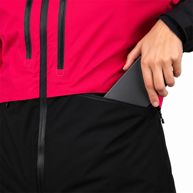 Women's ski jacket ELAN ROGLA PINK in a vivid pink color. Advanced two-layer construction with a polyurethane membrane provides a water column of 20,000 mm and breathability 20,000 g/m²/24 h. The jacket has insulation made of 100% recycled polyester, 80 g/m² on the torso and 60 g/m² on the sleeves and hood, taped seams, waterproof zippers, two-way adjustable hood, ski pass pocket, and internal snow protection.
